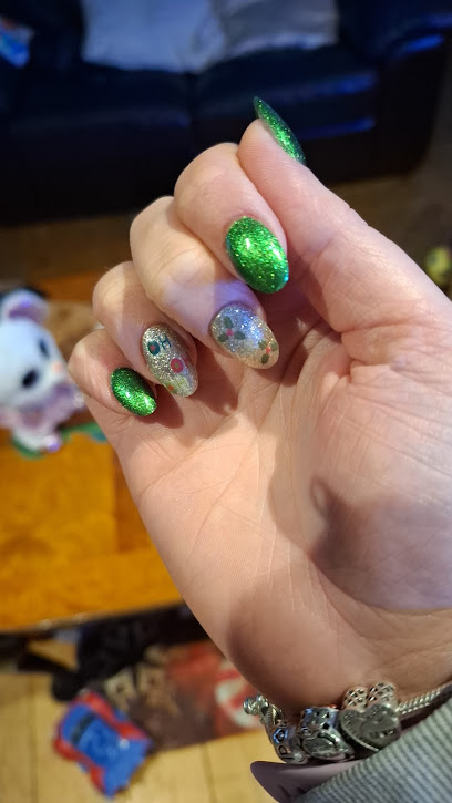 Glittered green and silver nail art on a client's hand, painted at Only One Beauty Salon in St Helier